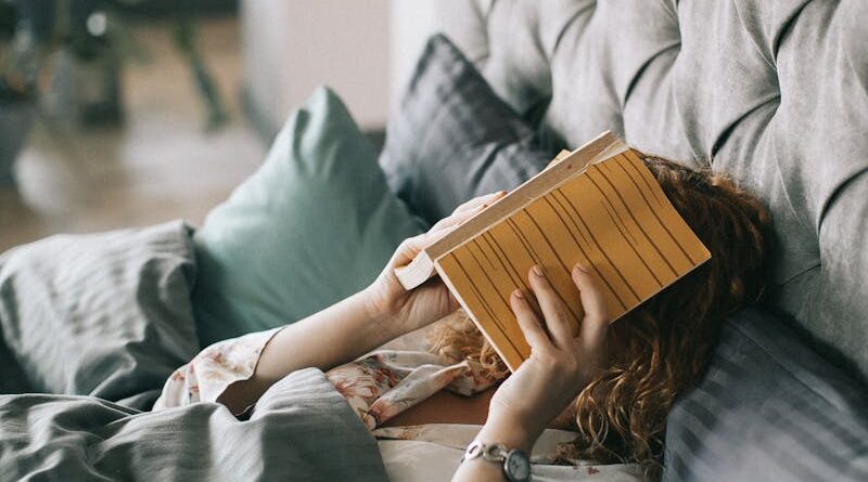 Woman Covering Face With Book on Bed