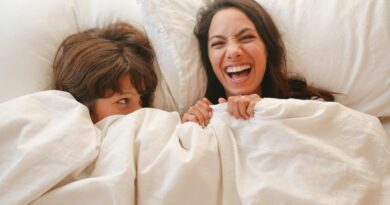 Happy Couple lying on Bed