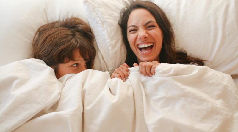 Happy Couple lying on Bed