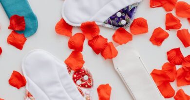 Hygienic Pads and Flowers Petals on White Background