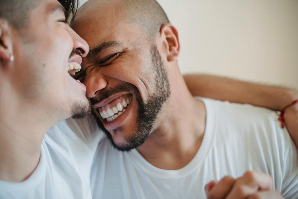 Two Men Laughing and Hugging Referentes LGTBIQA+