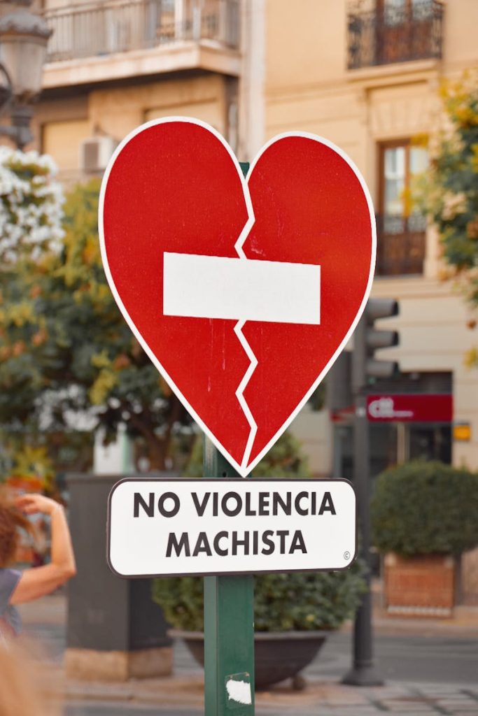A street sign in Málaga, Spain highlighting the 'No Violencia Machista' message. Urban setting. No a la violencia machista