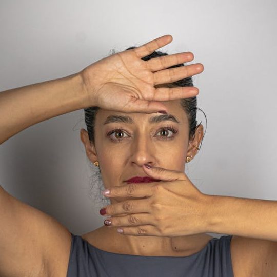 Elegant portrait of a woman with a thoughtful pose in a studio setting. violencia machista